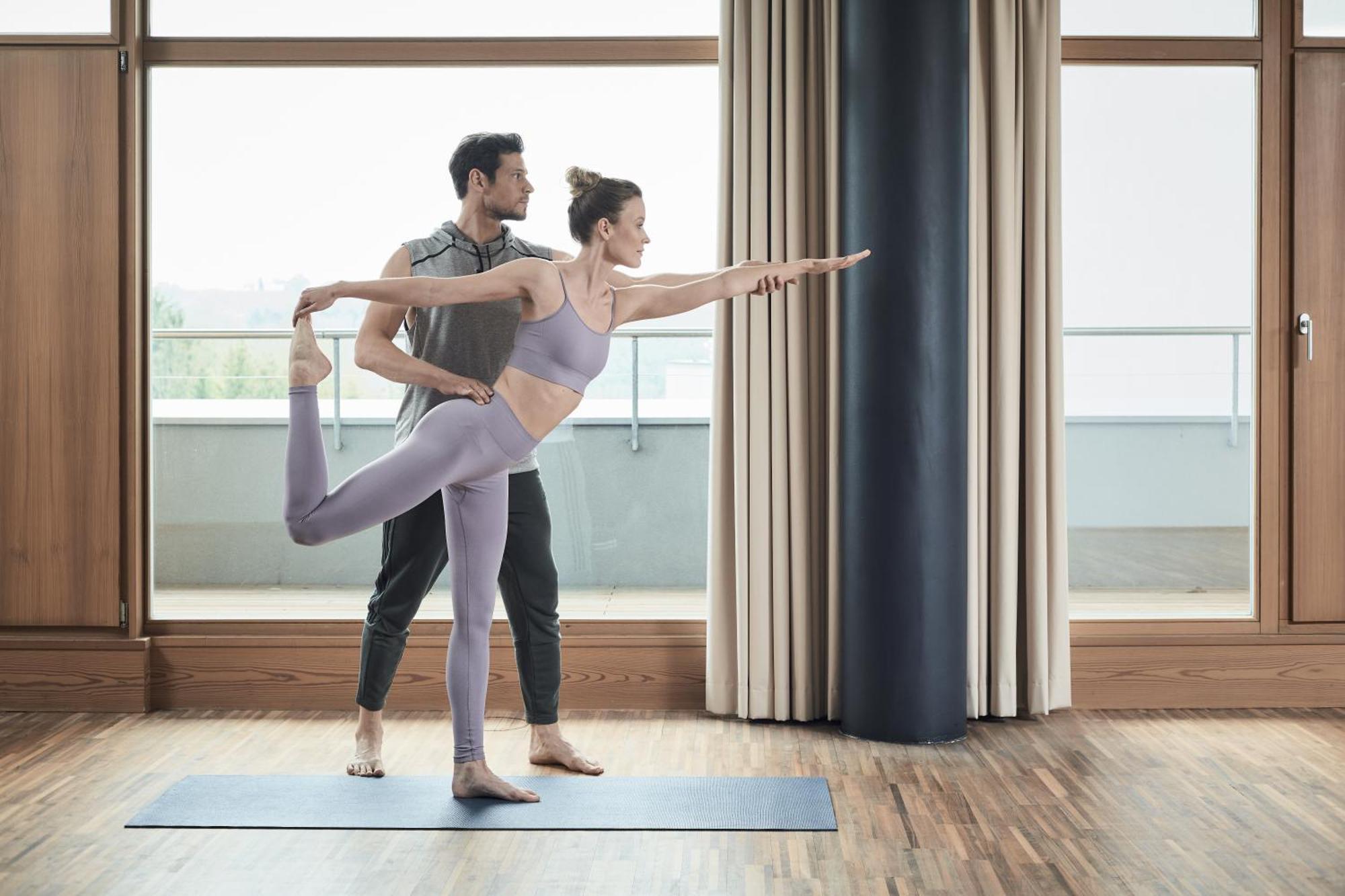 Falkensteiner Balance Resort Stegersbach - Adults Only Eksteriør billede A woman practicing yoga with a personal trainer